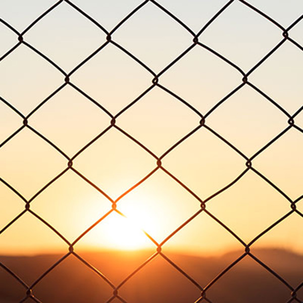 Chainlink fence at sunset