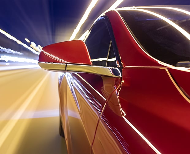 red car and speeding lights